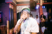 a man in a hat singing into a microphone