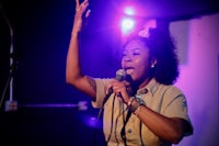 a woman singing into a microphone