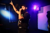 a man with a beard singing into a microphone